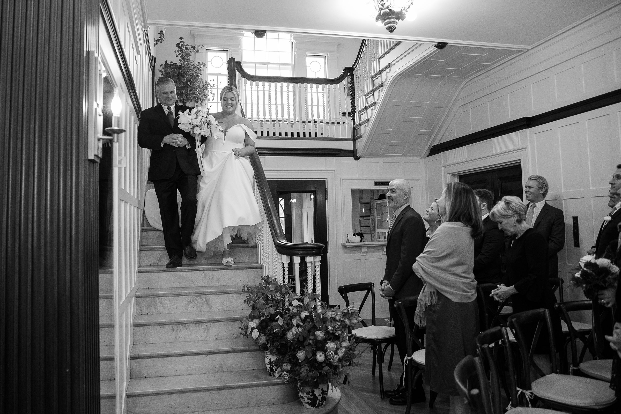 bride walking down the staircase with her dad for intimate wedding