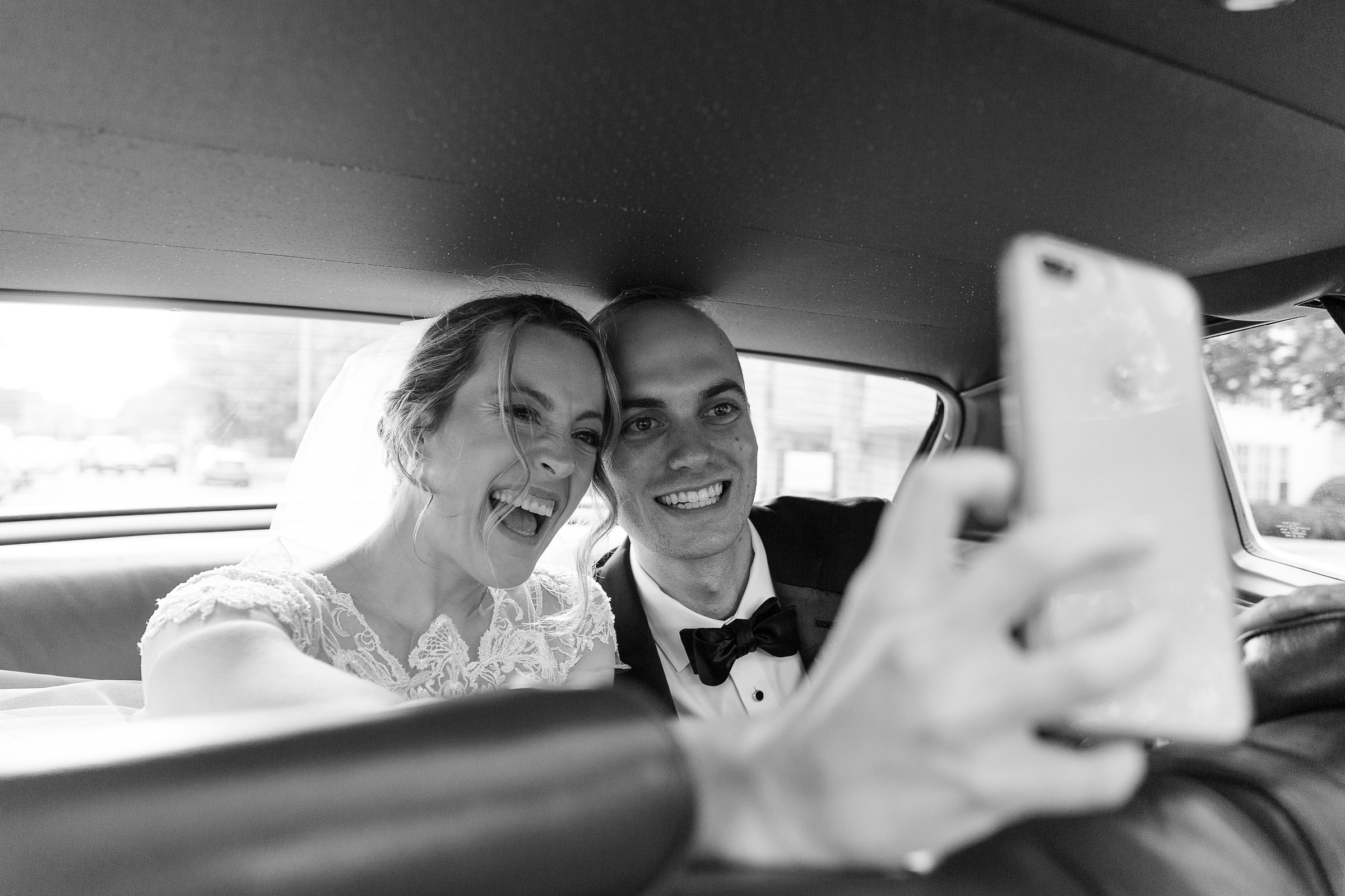 bride and groom in getaway car for vermont fall wedding