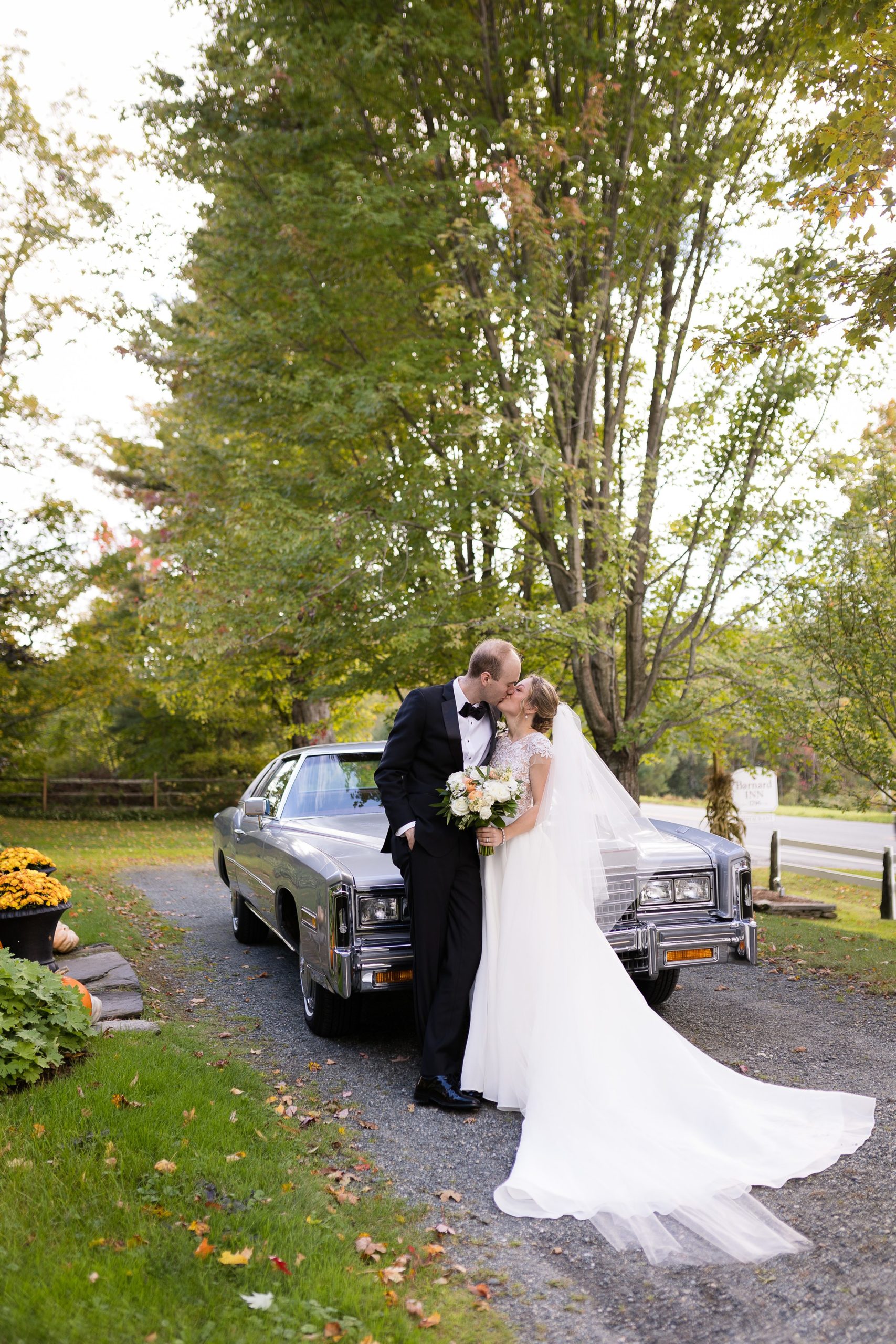 bride and groom in getaway car for vermont fall wedding