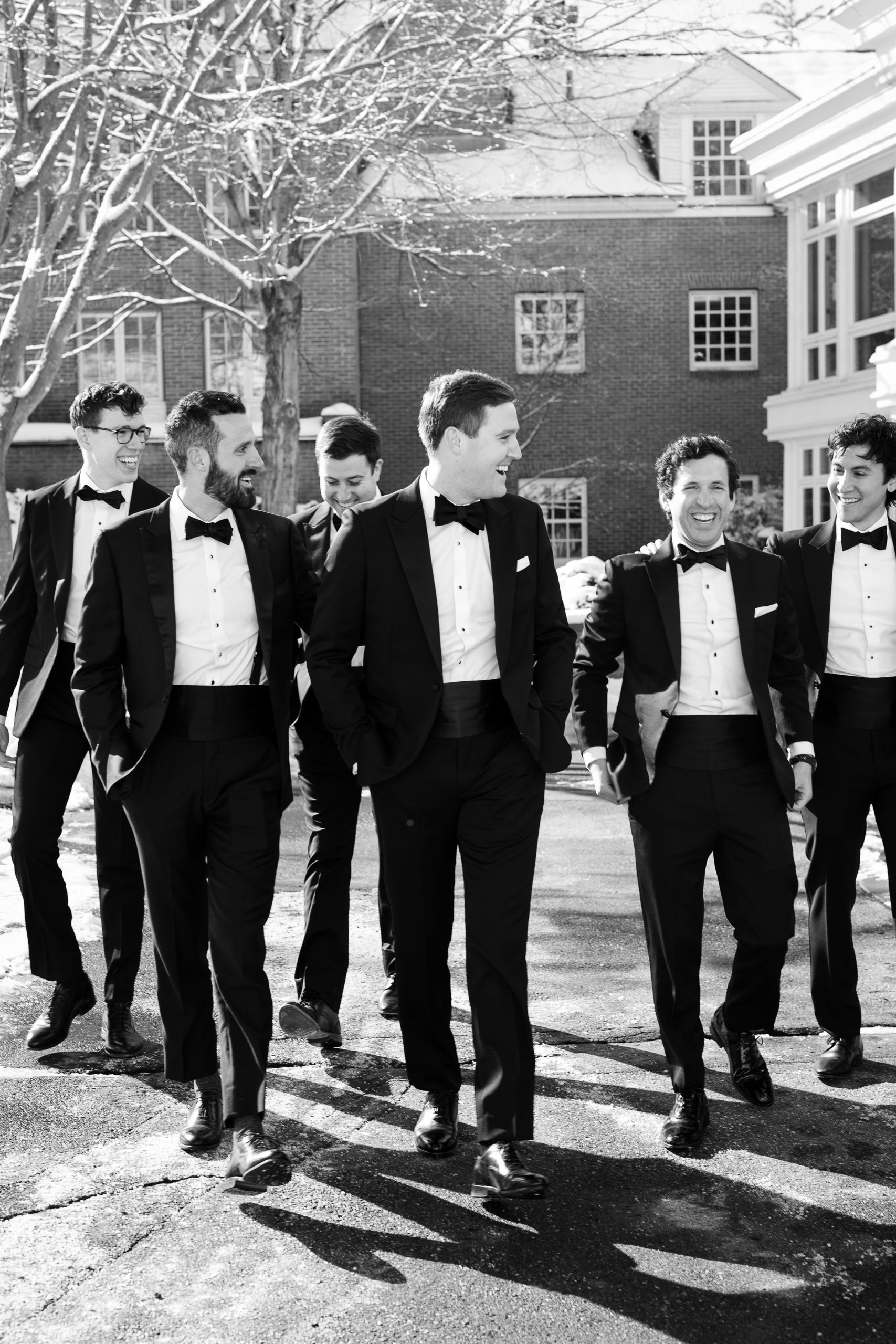 Groom and groomsmen in tuxedos for winter wedding 