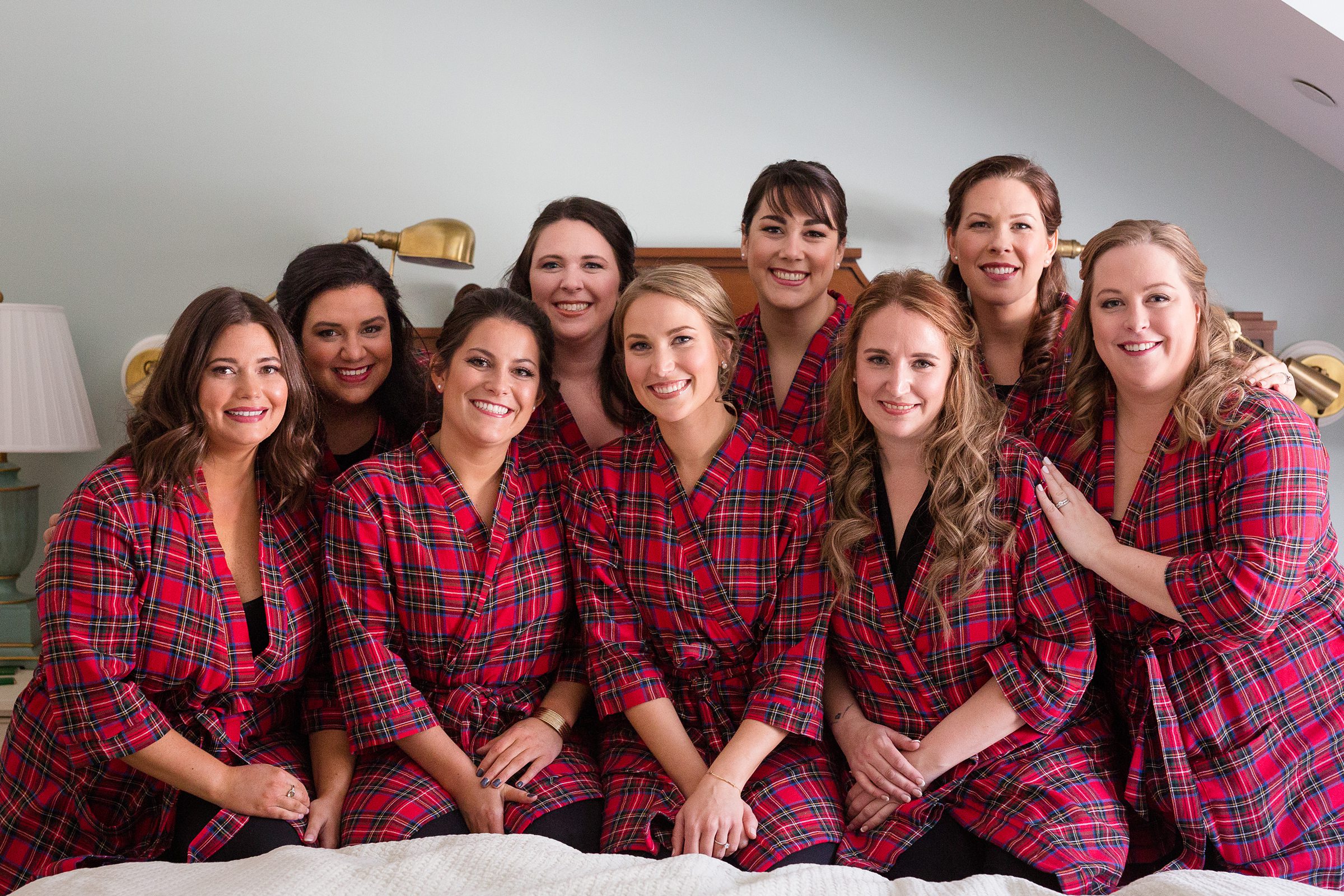 Bride and bridesmaids in flannel robes for winter wedding at the Woodstock Inn 