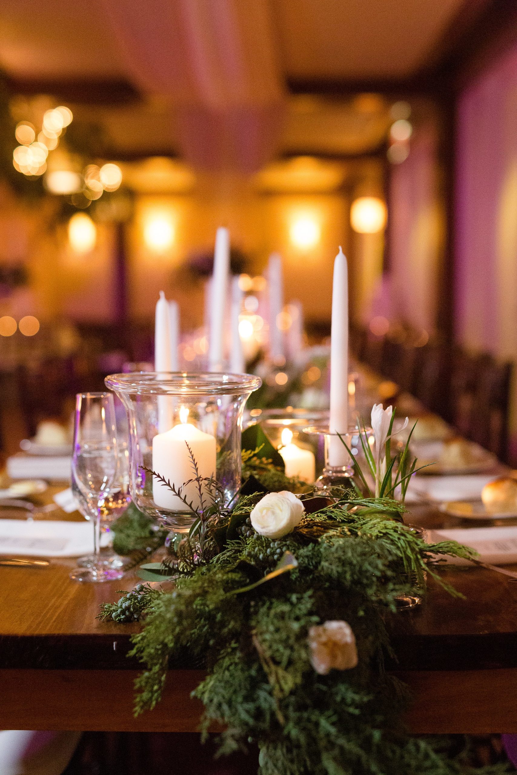 Winter tablescape with candlestick candles and greenery 
