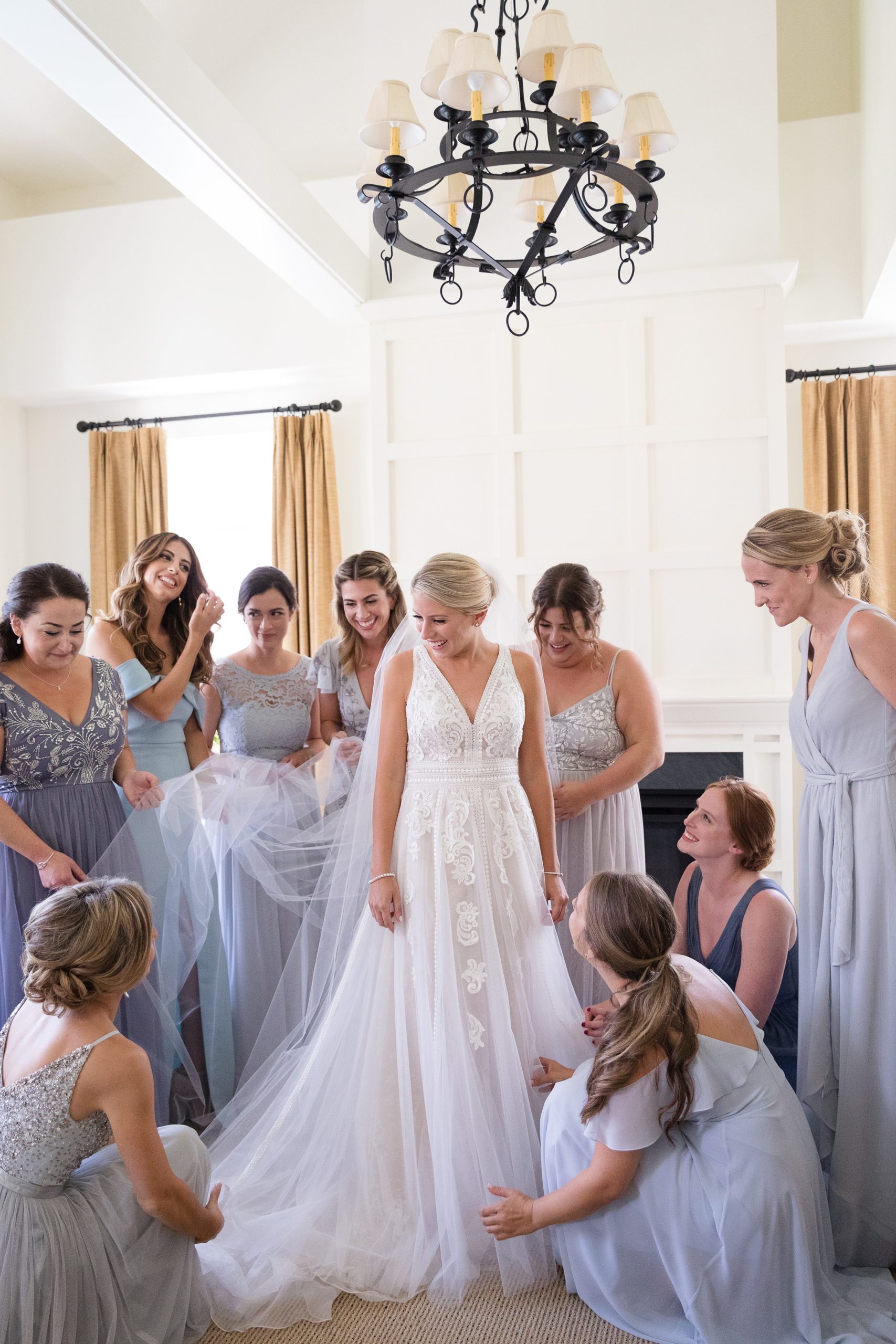 Bride getting ready with bridesmaids all around her