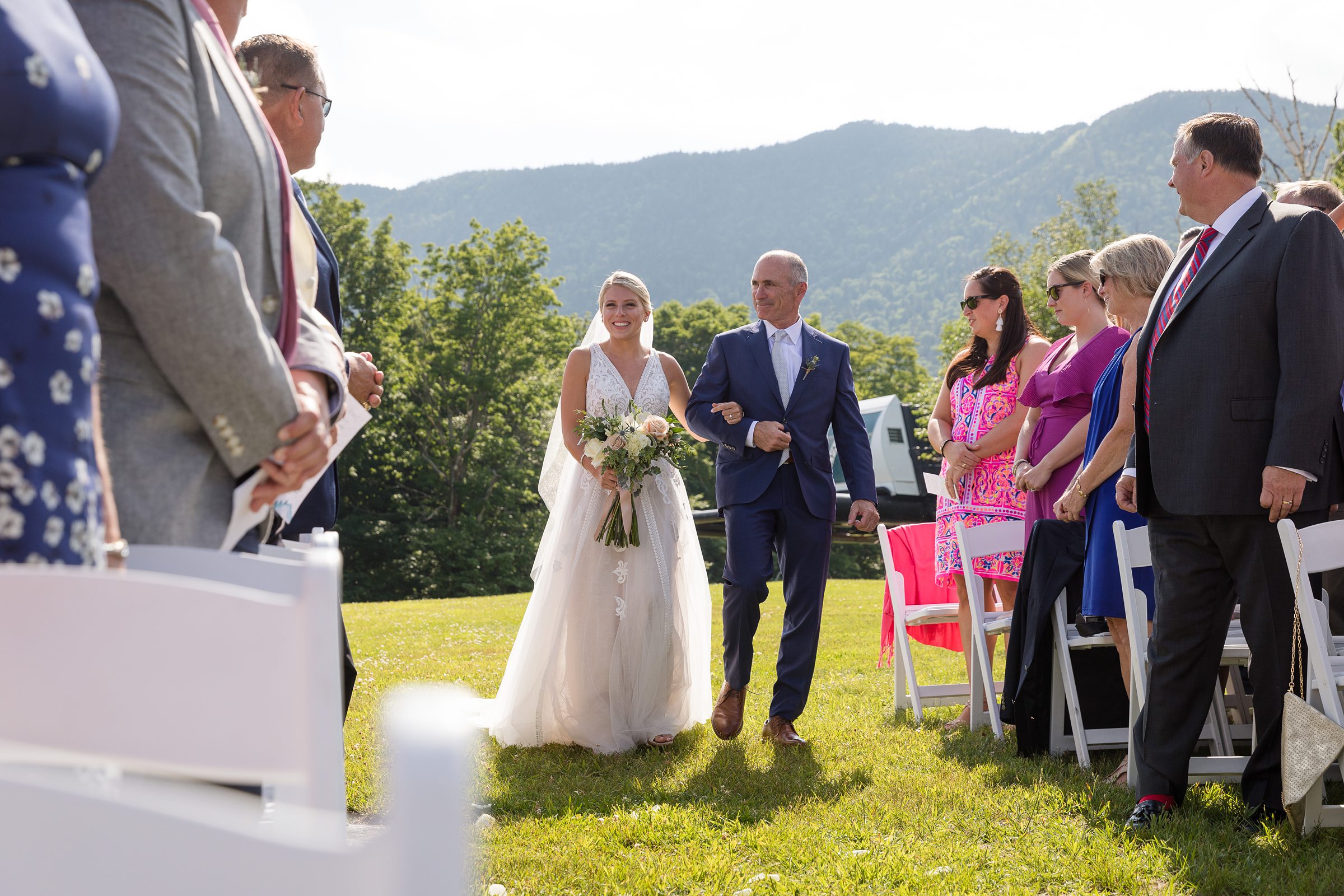 Bride and her father walking down the aisle at the mountain top at Sugarbush Resort