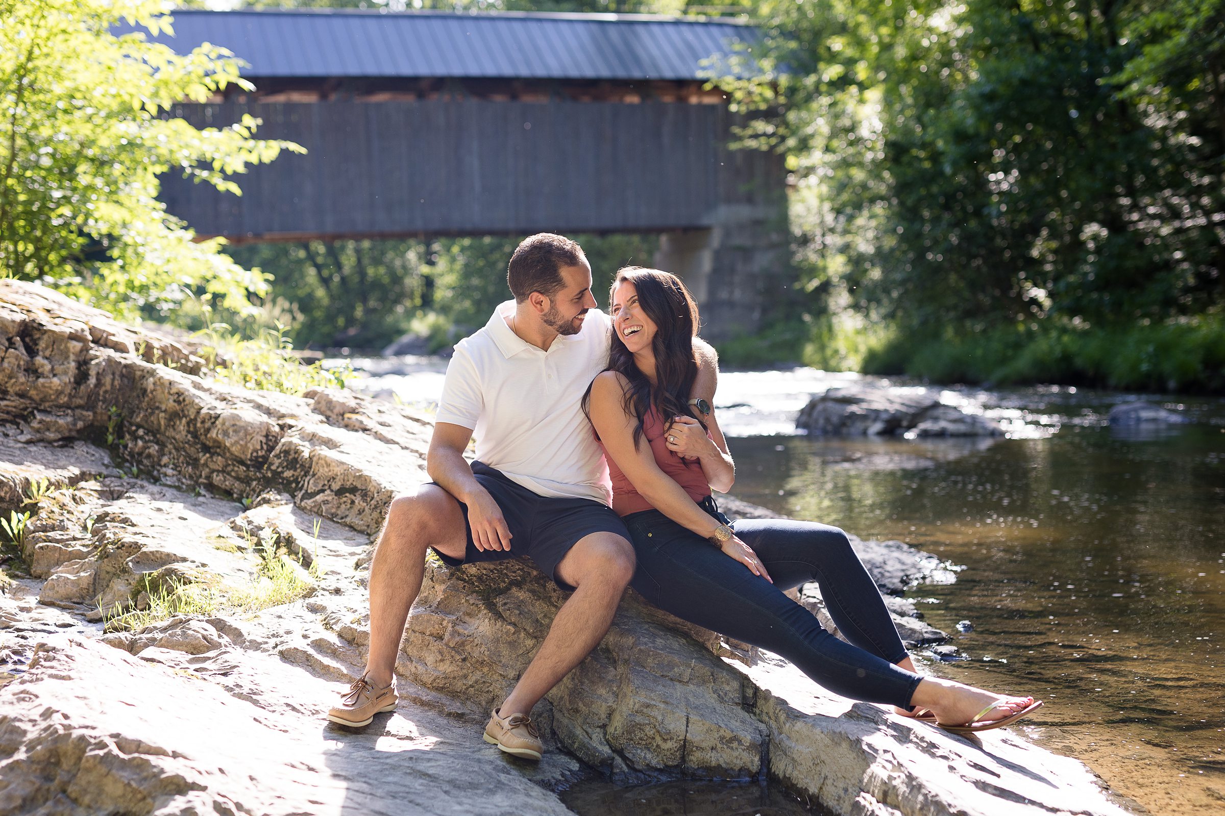 Engagement photos in front of a covered bridge 