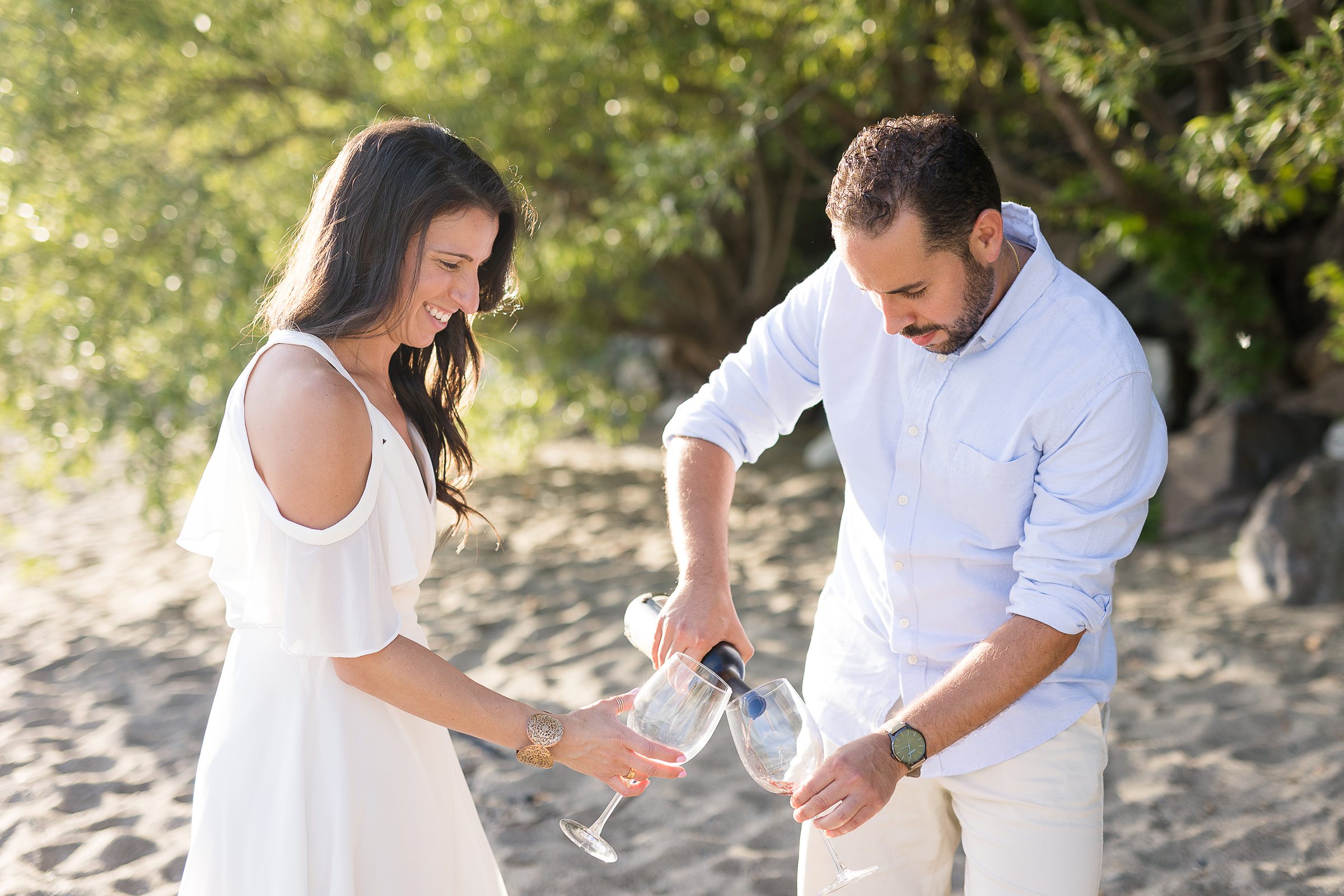 Lake Champlain engagement photos on North Beach with a bottle of wine