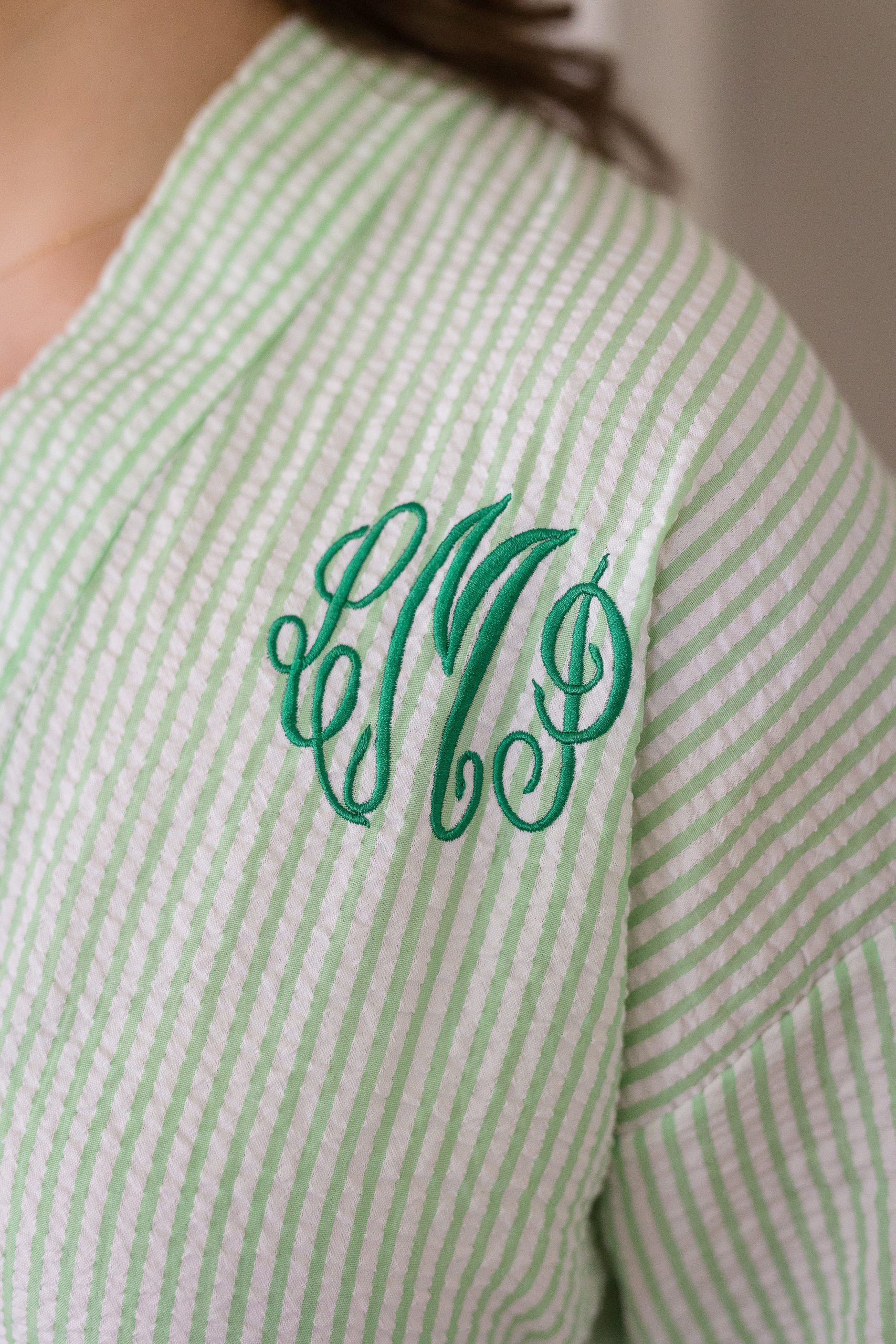 Bridesmaids getting ready robes with green pinstripes and monogramming 