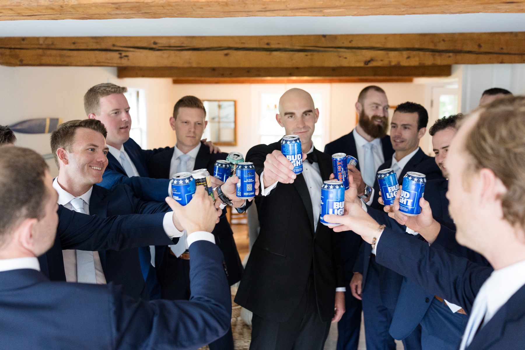 groom and groomsmen cheersing bud light beers