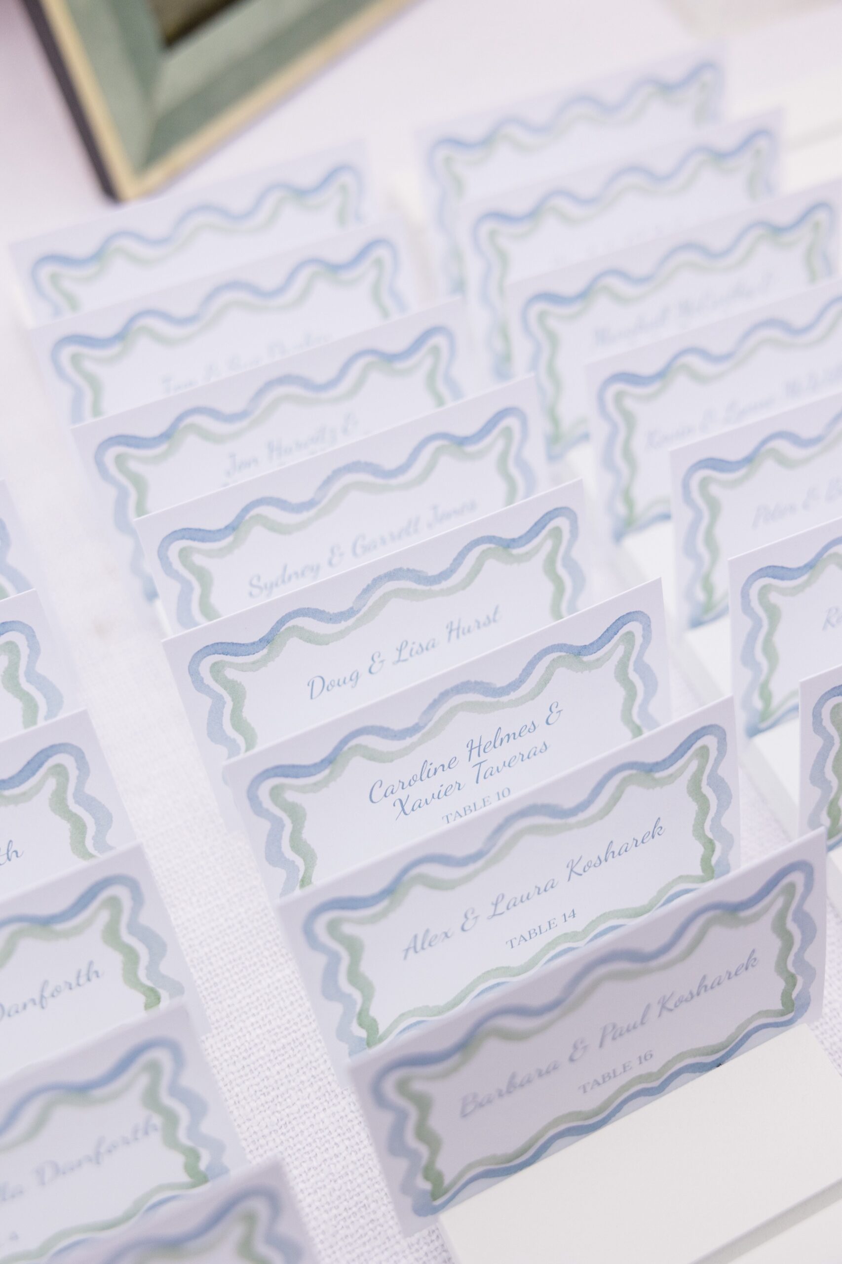 close up detail shot of reception seating cards with blue and green pattern