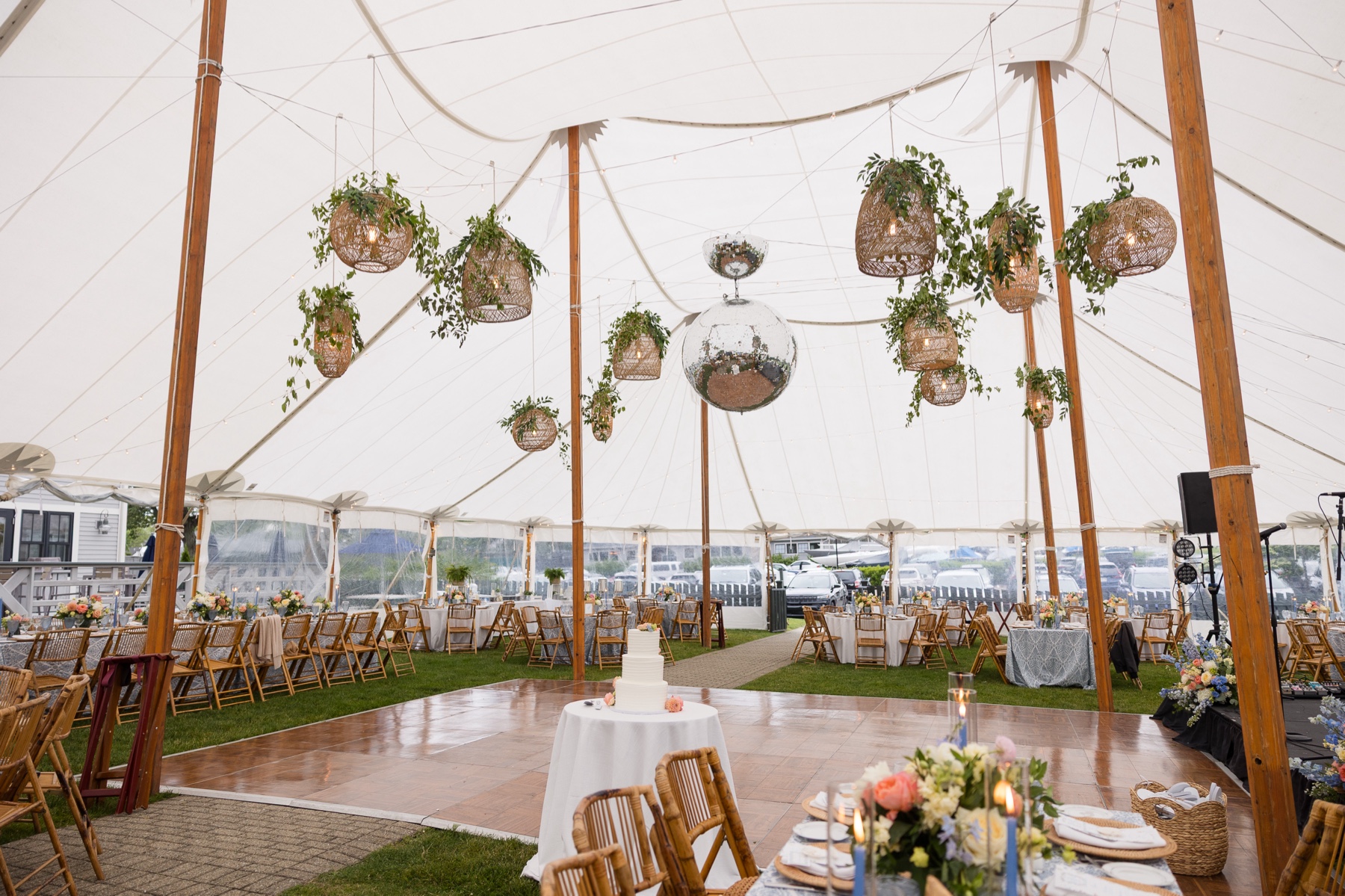 wedding reception under tent with rattan lanterns and disco balls