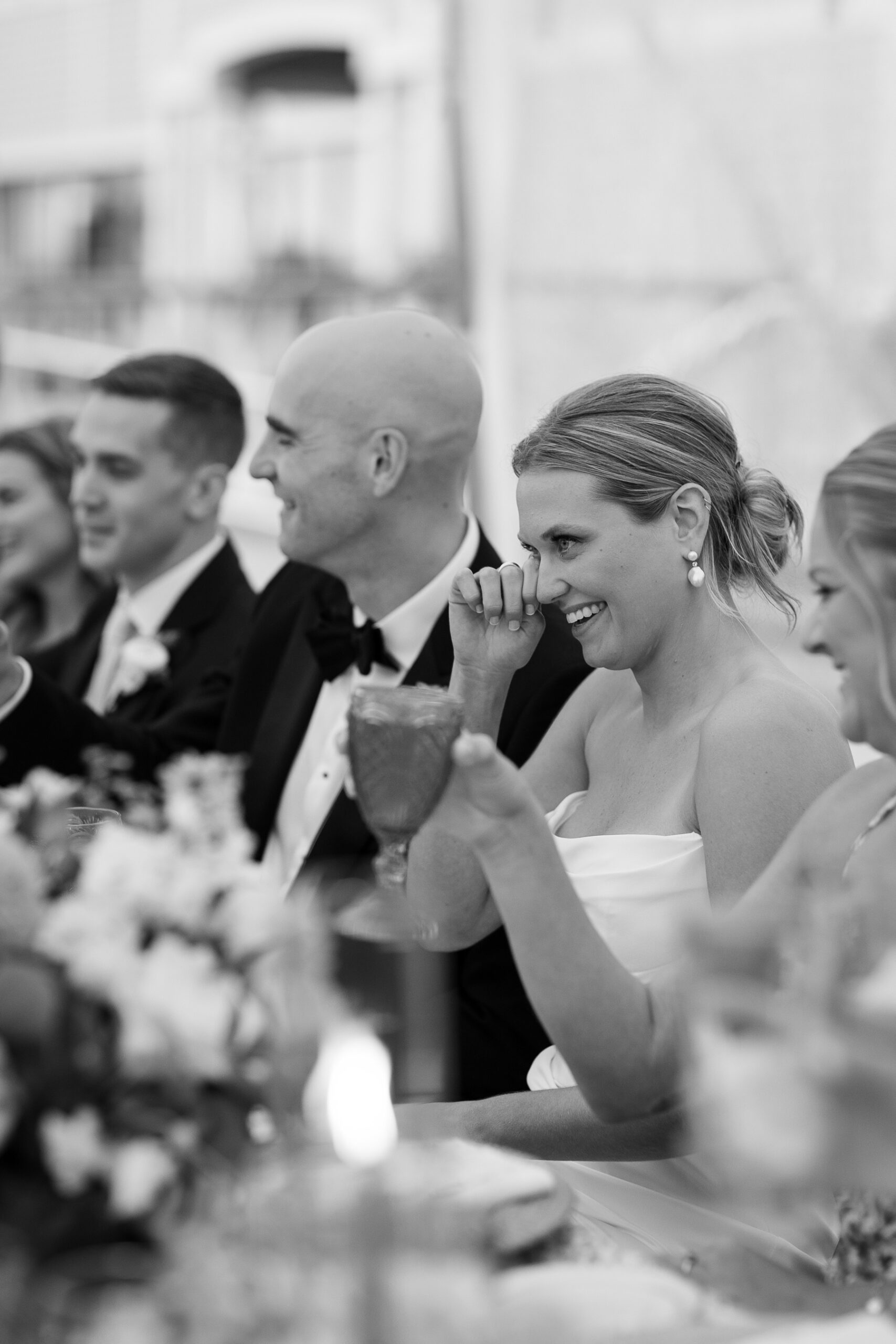 bride wiping a tear during her father's speech