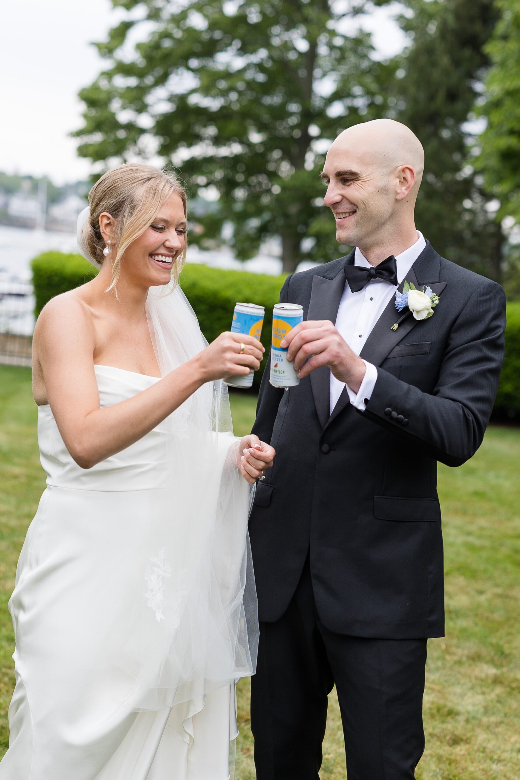 bride and groom cheersing with high noon cans